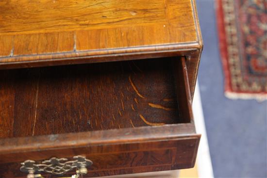 An early 18th century crossbanded kneehole desk, W.2ft 7in. D.1ft 7in. H.2ft 7in.